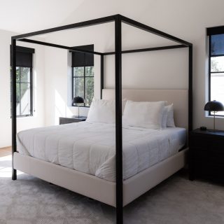 Step inside this stunning primary suite - we love how the use of black accents, from the shades and bedside tables to the shower tile, ties the bedroom and bathroom together with modern, cohesive style!🖤 🤍